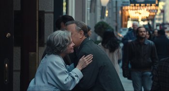 Movie still from “A Beautiful Day in the Neighborhood” (2019), directed by Marielle Heller – An older man and woman kissing on the street; Medium shot, Over the shoulder angle