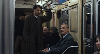 Movie still from “A Beautiful Day in the Neighborhood” (2019), directed by Marielle Heller – A man in a wheelchair on a subway train; Medium shot, Over the shoulder angle