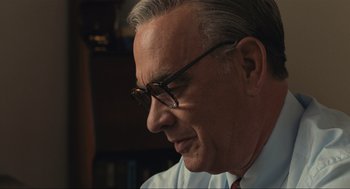 Movie still from “A Beautiful Day in the Neighborhood” (2019), directed by Marielle Heller – An older man wearing glasses looking down at a book; Close Up shot, Over the shoulder angle