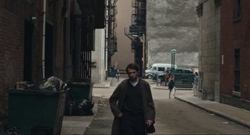 Movie still from “A Beautiful Day in the Neighborhood” (2019), directed by Marielle Heller – A man walking down a street with a car in the background; Wide shot, High angle