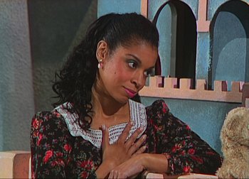 Movie still from “A Beautiful Day in the Neighborhood” (2019), directed by Marielle Heller – A young woman with her hands on her chest; Close Up shot, High angle