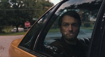 Movie still from “A Beautiful Day in the Neighborhood” (2019), directed by Marielle Heller – A man sitting in the driver's seat of a yellow taxi cab; Close Up shot, Over the shoulder angle
