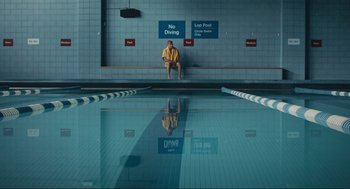Movie still from “A Beautiful Day in the Neighborhood” (2019), directed by Marielle Heller – A man sitting in front of a swimming pool; Extreme Wide shot, High angle