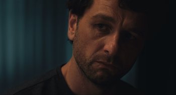 Movie still from “A Beautiful Day in the Neighborhood” (2019), directed by Marielle Heller – A man's face in a black shirt; Close Up shot, Over the shoulder angle