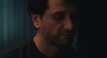 Movie still from “A Beautiful Day in the Neighborhood” (2019), directed by Marielle Heller – A person with a beard looking down; Close Up shot, Over the shoulder angle