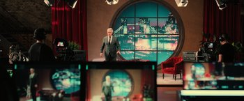 A man standing in front of a television set