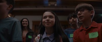 Movie still from “A Christmas Mystery” (2022), directed by Alex Ranarivelo – A girl with long hair is looking up at the ceiling; Close Up shot, Over the shoulder angle