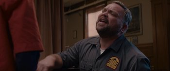 Movie still from “A Christmas Mystery” (2022), directed by Alex Ranarivelo – A man with a beard is crying in a room; Close Up shot, Low angle