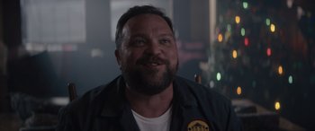 Movie still from “A Christmas Mystery” (2022), directed by Alex Ranarivelo – A person smiling for the camera; Close Up shot, Low angle