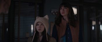 Movie still from “A Christmas Mystery” (2022), directed by Alex Ranarivelo – Two young women are standing next to each other in a room; Close Up shot, Over the shoulder angle