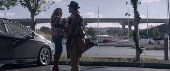 Movie still from “A Christmas Mystery” (2022), directed by Alex Ranarivelo – A man and a woman standing next to each other on the side of the road; Wide shot, Low angle