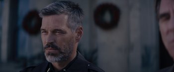 Movie still from “A Christmas Mystery” (2022), directed by Alex Ranarivelo – A person with a gray beard; Close Up shot, Over the shoulder angle