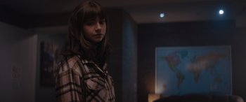 Movie still from “A Christmas Mystery” (2022), directed by Alex Ranarivelo – A woman standing in front of a projection screen; Medium shot, Over the shoulder angle