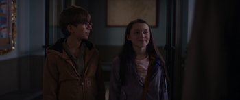 Movie still from “A Christmas Mystery” (2022), directed by Alex Ranarivelo – Two people standing next to each other in a room; Medium shot, Over the shoulder angle