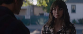 Movie still from “A Christmas Mystery” (2022), directed by Alex Ranarivelo – A young woman is standing outside in the sunlight; Close Up shot, Over the shoulder angle