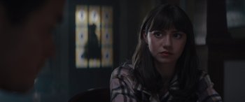 Movie still from “A Christmas Mystery” (2022), directed by Alex Ranarivelo – A woman sitting in front of stained glass window; Close Up shot, Over the shoulder angle