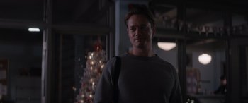 Movie still from “A Christmas Mystery” (2022), directed by Alex Ranarivelo – A man standing in front of a christmas tree; Close Up shot, Over the shoulder angle