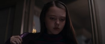 Movie still from “A Christmas Mystery” (2022), directed by Alex Ranarivelo – A young girl with long dark brown hair; Close Up shot, Low angle