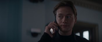 Movie still from “A Christmas Mystery” (2022), directed by Alex Ranarivelo – A person talking on a cell phone; Close Up shot, Low angle