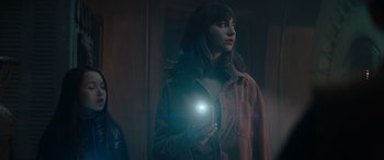 Movie still from “A Christmas Mystery” (2022), directed by Alex Ranarivelo – A woman is holding a flashlight in her hand; Medium shot, Over the shoulder angle