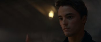 Movie still from “A Christmas Mystery” (2022), directed by Alex Ranarivelo – A young man is looking into the distance; Close Up shot, Over the shoulder angle