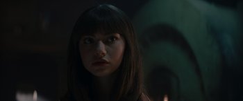 Movie still from “A Christmas Mystery” (2022), directed by Alex Ranarivelo – A woman with long black hair looking at the camera; Close Up shot, Over the shoulder angle