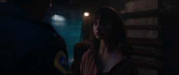 Movie still from “A Christmas Mystery” (2022), directed by Alex Ranarivelo – A woman is standing in a dark room; Close Up shot, Over the shoulder angle