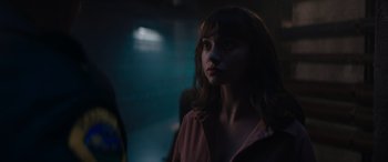 Movie still from “A Christmas Mystery” (2022), directed by Alex Ranarivelo – A woman is standing in a dark room; Close Up shot, Over the shoulder angle