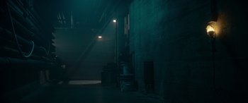Movie still from “A Christmas Mystery” (2022), directed by Alex Ranarivelo – A dark room with a light on the wall; Extreme Wide shot, High angle