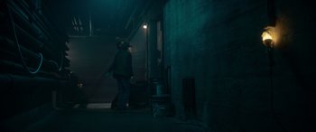 Movie still from “A Christmas Mystery” (2022), directed by Alex Ranarivelo – A person walking in a dark room at night; Wide shot, High angle