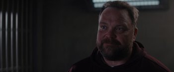 Movie still from “A Christmas Mystery” (2022), directed by Alex Ranarivelo – A person with a beard; Close Up shot, Over the shoulder angle