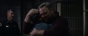 Movie still from “A Christmas Mystery” (2022), directed by Alex Ranarivelo – A man hugging another man with his hands on his head; Close Up shot, Over the shoulder angle