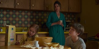 Movie still from “A Christmas Story Christmas” (2022), directed by Clay Kaytis – A woman and two children sitting at a kitchen table; Medium shot, Over the shoulder angle