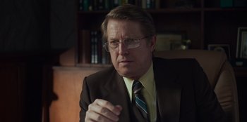 Movie still from “A Christmas Story Christmas” (2022), directed by Clay Kaytis – A person wearing a suit and tie; Close Up shot, Over the shoulder angle