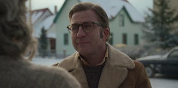 Movie still from “A Christmas Story Christmas” (2022), directed by Clay Kaytis – A person wearing glasses and a coat; Close Up shot, Over the shoulder angle