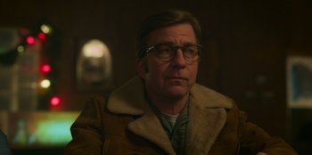 Movie still from “A Christmas Story Christmas” (2022), directed by Clay Kaytis – A man wearing glasses and a brown jacket; Close Up shot, Over the shoulder angle