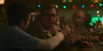 Movie still from “A Christmas Story Christmas” (2022), directed by Clay Kaytis – A man sitting at a table with a glass of wine; Close Up shot, Over the shoulder angle