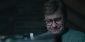 Movie still from “A Christmas Story Christmas” (2022), directed by Clay Kaytis – An older man wearing glasses looking down at a computer screen; Close Up shot, Over the shoulder angle