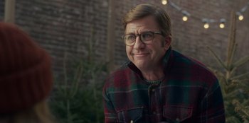 Movie still from “A Christmas Story Christmas” (2022), directed by Clay Kaytis – A man wearing glasses and a plaid shirt; Close Up shot, Over the shoulder angle