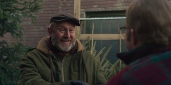 Movie still from “A Christmas Story Christmas” (2022), directed by Clay Kaytis – An older man wearing a hat and a green jacket talking to a younger man; Close Up shot, Over the shoulder angle