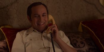 Movie still from “A Christmas Story Christmas” (2022), directed by Clay Kaytis – A man sitting on a couch talking on a phone; Close Up shot, High angle