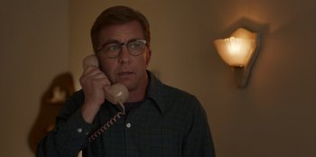 Movie still from “A Christmas Story Christmas” (2022), directed by Clay Kaytis – A man with glasses talking on a phone; Close Up shot, Low angle