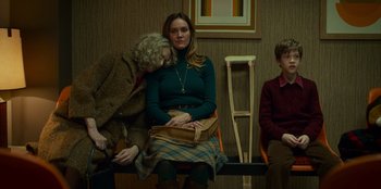 Movie still from “A Christmas Story Christmas” (2022), directed by Clay Kaytis – Two women and a man sitting on a bench; Medium shot, Low angle