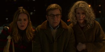 Movie still from “A Christmas Story Christmas” (2022), directed by Clay Kaytis – A man and two women standing next to each other in the dark; Medium shot, Over the shoulder angle