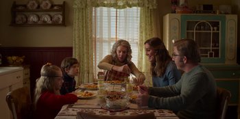 Movie still from “A Christmas Story Christmas” (2022), directed by Clay Kaytis – A group of people sitting around a table eating food; Medium shot, Over the shoulder angle