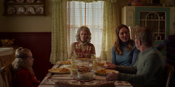 Movie still from “A Christmas Story Christmas” (2022), directed by Clay Kaytis – Two women sitting at a table with plates of food on it; Medium shot, Over the shoulder angle