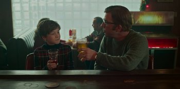 Movie still from “A Christmas Story Christmas” (2022), directed by Clay Kaytis – A man and a boy sitting at a bar drinking beer; Medium shot, Over the shoulder angle