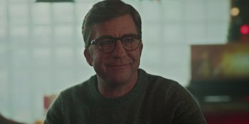 Movie still from “A Christmas Story Christmas” (2022), directed by Clay Kaytis – A person wearing glasses and a sweater; Close Up shot, Over the shoulder angle