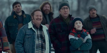 Two men and a boy standing in the snow