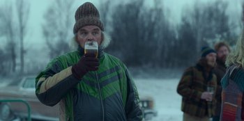 Movie still from “A Christmas Story Christmas” (2022), directed by Clay Kaytis – A man drinking a glass of beer in the snow; Close Up shot, Over the shoulder angle